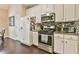 Efficient kitchen with stainless steel appliances, gas range and crisp white cabinetry at 1719 Kings Cross Ct, Hoschton, GA 30548