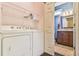 Laundry room featuring a full size washer and dryer set with white wire shelving at 1719 Kings Cross Ct, Hoschton, GA 30548