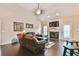 Comfortable living room featuring a fireplace, vaulted ceilings and rich hardwood flooring at 1719 Kings Cross Ct, Hoschton, GA 30548