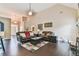 Open concept living room with hardwood floors, fireplace and neutral color palette at 1719 Kings Cross Ct, Hoschton, GA 30548