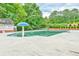 Community pool with a mushroom water feature and a view of mature trees at 1719 Kings Cross Ct, Hoschton, GA 30548