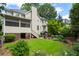 Spacious backyard featuring an upper screened porch and lower-level patio and BBQ area at 400 Fieldstone Lndg, Alpharetta, GA 30005