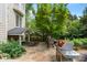 Outdoor stone patio with a BBQ grill, dining area, and access to the screened porch at 400 Fieldstone Lndg, Alpharetta, GA 30005