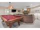 Finished basement with pool table, stone fireplace, large TV, and comfortable seating at 400 Fieldstone Lndg, Alpharetta, GA 30005