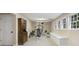 Bright basement gym with exercise machine, storage cabinet, and natural light from windows at 400 Fieldstone Lndg, Alpharetta, GA 30005