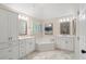 Beautiful white bathroom with marble floors, a soaking tub, and separate and vanities at 400 Fieldstone Lndg, Alpharetta, GA 30005