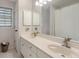 Bright bathroom with double sinks, white cabinets, a large mirror, and a shower/tub combo at 400 Fieldstone Lndg, Alpharetta, GA 30005