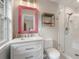 Updated bathroom with a stylish pink framed mirror, modern fixtures, and a glass-enclosed shower at 400 Fieldstone Lndg, Alpharetta, GA 30005