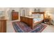 Elegant bedroom with wood furniture, decorative rug, and natural light from windows at 400 Fieldstone Lndg, Alpharetta, GA 30005