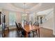 Elegant dining room with hardwood floors, large table, and natural light from shuttered windows at 400 Fieldstone Lndg, Alpharetta, GA 30005