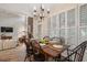 Cozy dining area with large windows, hardwood floors, and chandelier lighting at 400 Fieldstone Lndg, Alpharetta, GA 30005