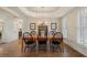 Formal dining room features a modern chandelier, hardwood floors, and natural light from large windows at 400 Fieldstone Lndg, Alpharetta, GA 30005