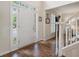 Bright foyer with hardwood floors, white trim, and staircase showcasing the home's entrance at 400 Fieldstone Lndg, Alpharetta, GA 30005