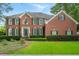 Beautiful two-story brick home with a well-manicured lawn and dark green shutters at 400 Fieldstone Lndg, Alpharetta, GA 30005