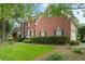 Well-kept brick home featuring manicured landscaping and an expansive green lawn at 400 Fieldstone Lndg, Alpharetta, GA 30005