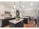 Open kitchen with granite countertops, stainless steel appliances, and a view to the dining area at 400 Fieldstone Lndg, Alpharetta, GA 30005