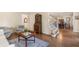 Open-concept living room with hardwood floors, staircase, and dining area at 400 Fieldstone Lndg, Alpharetta, GA 30005
