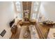 Open living area with fireplace, high ceilings, and large windows that let in lots of natural light at 400 Fieldstone Lndg, Alpharetta, GA 30005