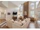 Comfortable living room featuring a stone fireplace, natural light, and hardwood flooring at 400 Fieldstone Lndg, Alpharetta, GA 30005