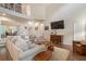 Bright living room with a large sectional sofa, bookshelf, and access to dining area at 400 Fieldstone Lndg, Alpharetta, GA 30005