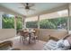 Relaxing screened porch with ceiling fan, wicker furniture, and dining table perfect for outdoor meals at 400 Fieldstone Lndg, Alpharetta, GA 30005
