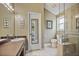 Modern bathroom with glass shower, toilet, and sink with vanity in neutral tones at 4274 Revere Cir, Marietta, GA 30062