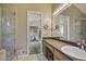 Modern bathroom with glass shower, large mirror, and vanity with ample storage at 4274 Revere Cir, Marietta, GA 30062