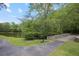 A tranquil lakeside path leading to a stone bridge, surrounded by lush greenery for a peaceful community walk at 4274 Revere Cir, Marietta, GA 30062