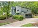 Two story home with gray siding, a two car garage, and a stairway leading to the front door at 4274 Revere Cir, Marietta, GA 30062