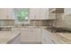 Bright kitchen featuring white cabinets, stainless steel appliances, and granite countertops at 4274 Revere Cir, Marietta, GA 30062