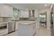 Bright eat-in kitchen with island, stainless appliances, gray subway tile backsplash, and marble countertops at 4274 Revere Cir, Marietta, GA 30062
