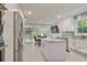 Open concept kitchen with white cabinets, island, stainless steel appliances, and access to deck at 4274 Revere Cir, Marietta, GA 30062