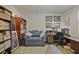 Cozy office area featuring a comfortable blue loveseat and a spacious desk setup with wooden drawers at 4274 Revere Cir, Marietta, GA 30062