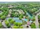 Stunning aerial view of a community with lush greenery, tennis courts, swimming pool and lake, creating a serene and active lifestyle at 6615 Callanwalde Ct, Suwanee, GA 30024