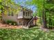 Green backyard of a home featuring a deck, patio, and natural landscaping at 6615 Callanwalde Ct, Suwanee, GA 30024