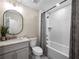 Well-lit bathroom with a tub-shower combo, modern vanity, and neutral color palette at 6615 Callanwalde Ct, Suwanee, GA 30024