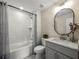 Well-lit bathroom with a tub-shower combo and a modern vanity at 6615 Callanwalde Ct, Suwanee, GA 30024