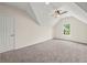 Upstairs bedroom featuring neutral paint, carpeted floors, and a double door closet at 6615 Callanwalde Ct, Suwanee, GA 30024