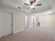 Spacious bedroom with a tray ceiling, ceiling fan, and multiple closets at 6615 Callanwalde Ct, Suwanee, GA 30024