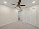 Carpeted bedroom featuring a ceiling fan and closet at 6615 Callanwalde Ct, Suwanee, GA 30024