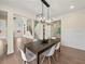 Dining room with hardwood floors, modern chandelier, and a view into the kitchen at 6615 Callanwalde Ct, Suwanee, GA 30024