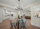 Dining room with a chandelier and table, view of the kitchen and living room at 6615 Callanwalde Ct, Suwanee, GA 30024