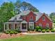Beautiful brick home with a manicured front yard and a covered porch, perfect for relaxing and enjoying the outdoors at 6615 Callanwalde Ct, Suwanee, GA 30024