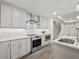 Modern kitchen featuring stainless steel appliances, white cabinets, and hardwood floors at 6615 Callanwalde Ct, Suwanee, GA 30024