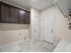 Laundry room with cabinets, washer and dryer hookups, and tile flooring at 6615 Callanwalde Ct, Suwanee, GA 30024