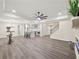 Open-concept living space with hardwood floors and a modern kitchen in the background at 6615 Callanwalde Ct, Suwanee, GA 30024