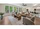 Bright living room with large windows, neutral furniture, and open floor plan at 6615 Callanwalde Ct, Suwanee, GA 30024