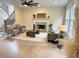 Comfortable living room with a fireplace, hardwood floors, and a ceiling fan, perfect for relaxation at 6615 Callanwalde Ct, Suwanee, GA 30024