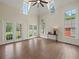 Bright living room with hardwood floors, a vaulted ceiling, and large windows offering plenty of natural light at 6615 Callanwalde Ct, Suwanee, GA 30024