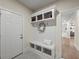 Mudroom with built-in bench, storage cubbies, and coat hooks at 6615 Callanwalde Ct, Suwanee, GA 30024